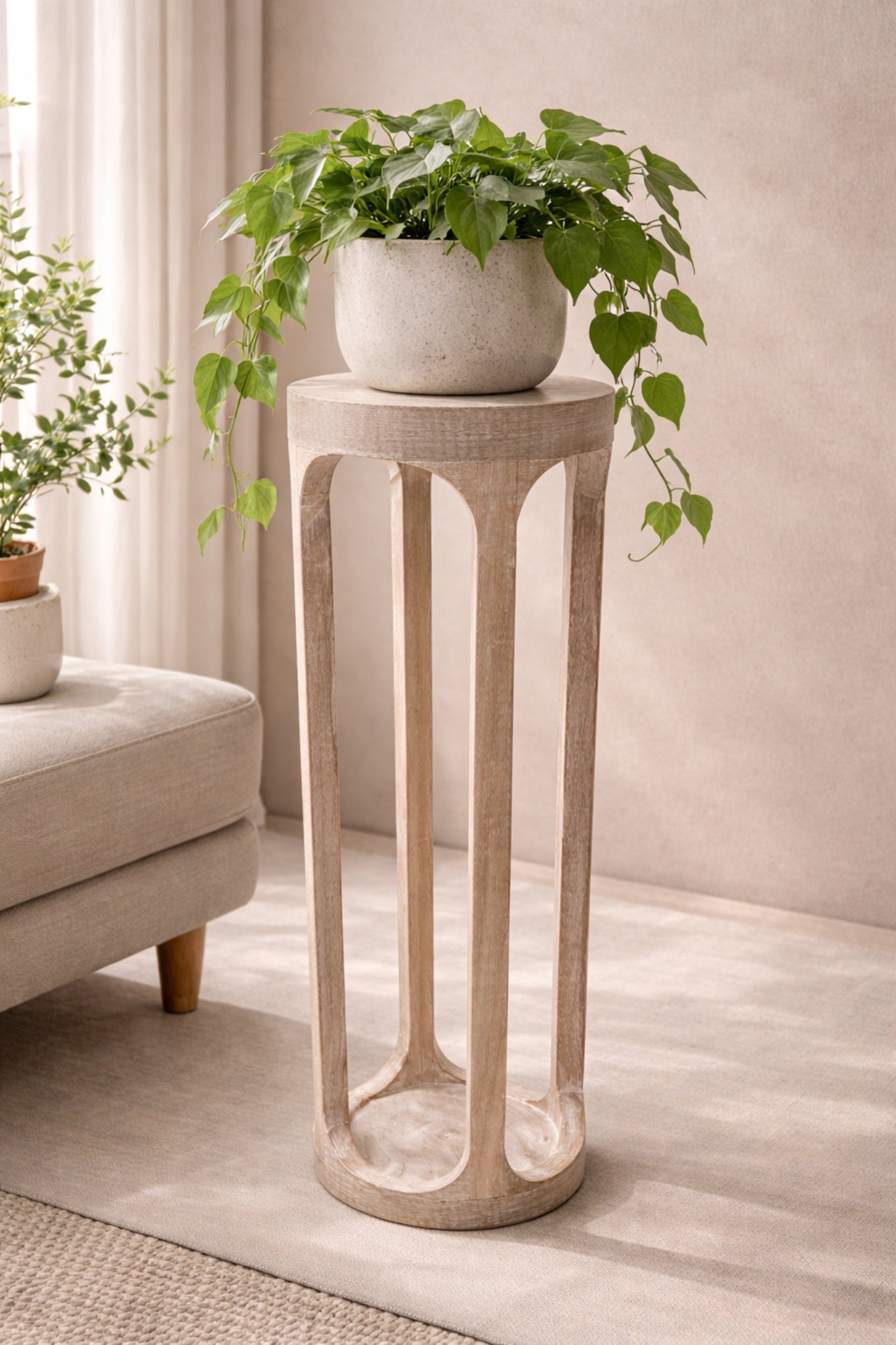 Minimalist wooden plant stand with greenery (1) Distressed White Wooden Pedestal Side Table – Slim Accent Stand for Living Room - Image 1
